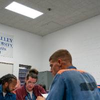 Students working during class with GVSU banners behind them on wall